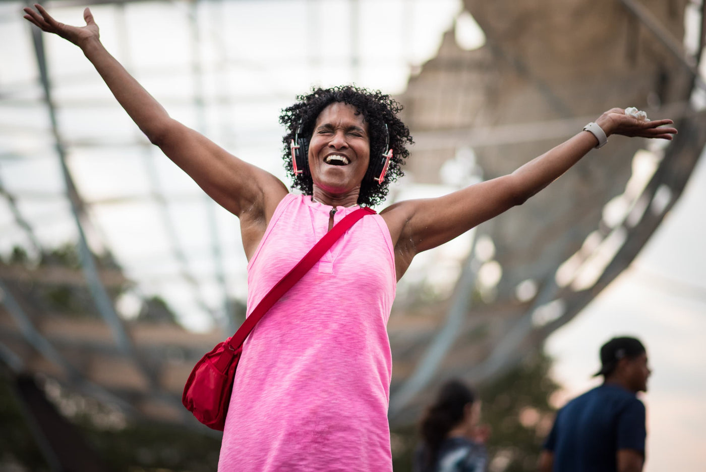 Quiet Events Silent Disco headphones for church. A woman praising with her eyes closed feeling joy and happiness with headphones.