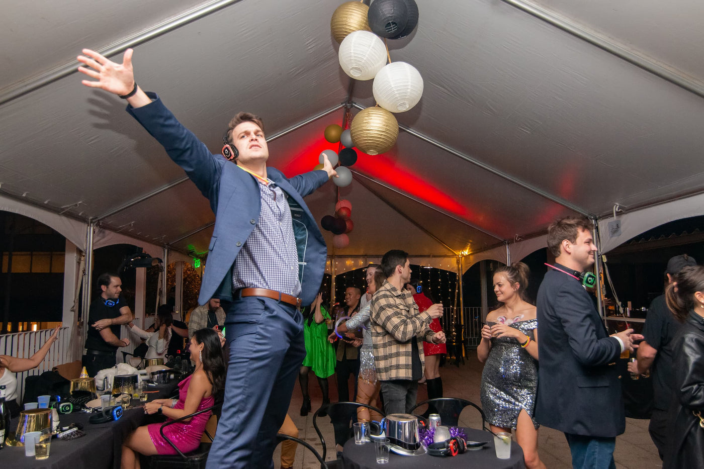 Quiet Events Silent Disco headphones for corporate. A group of professionals having fun in a corporate party listening to music with heaadphones.