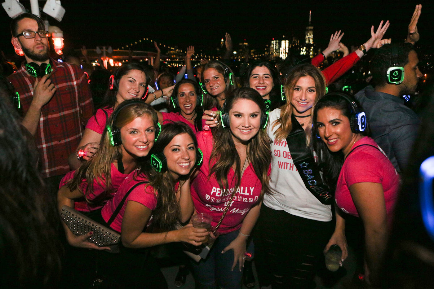 Quiet Events Silent Disco headphones for bachelorette parties.  A group of girls  celebrating and having fun on a night out wearing headphones.
