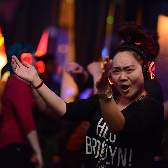 Quiet Events Silent Disco headphones for run walks. A participant having fun enjoying the moment wearing headphones.