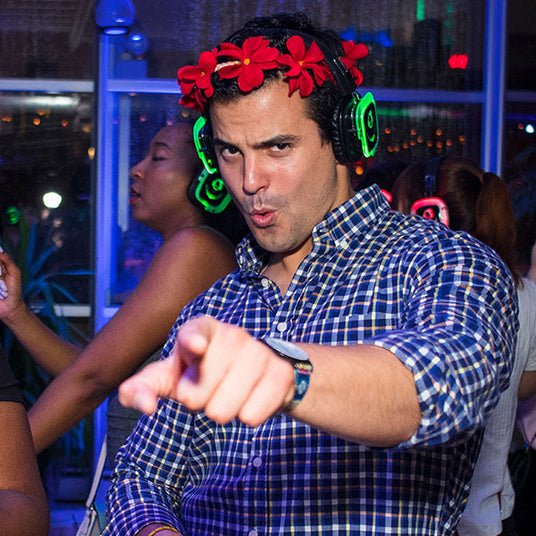 Quiet Events Silent Disco headphones for run walks. A participant having fun wearing headphones and pointing at you.