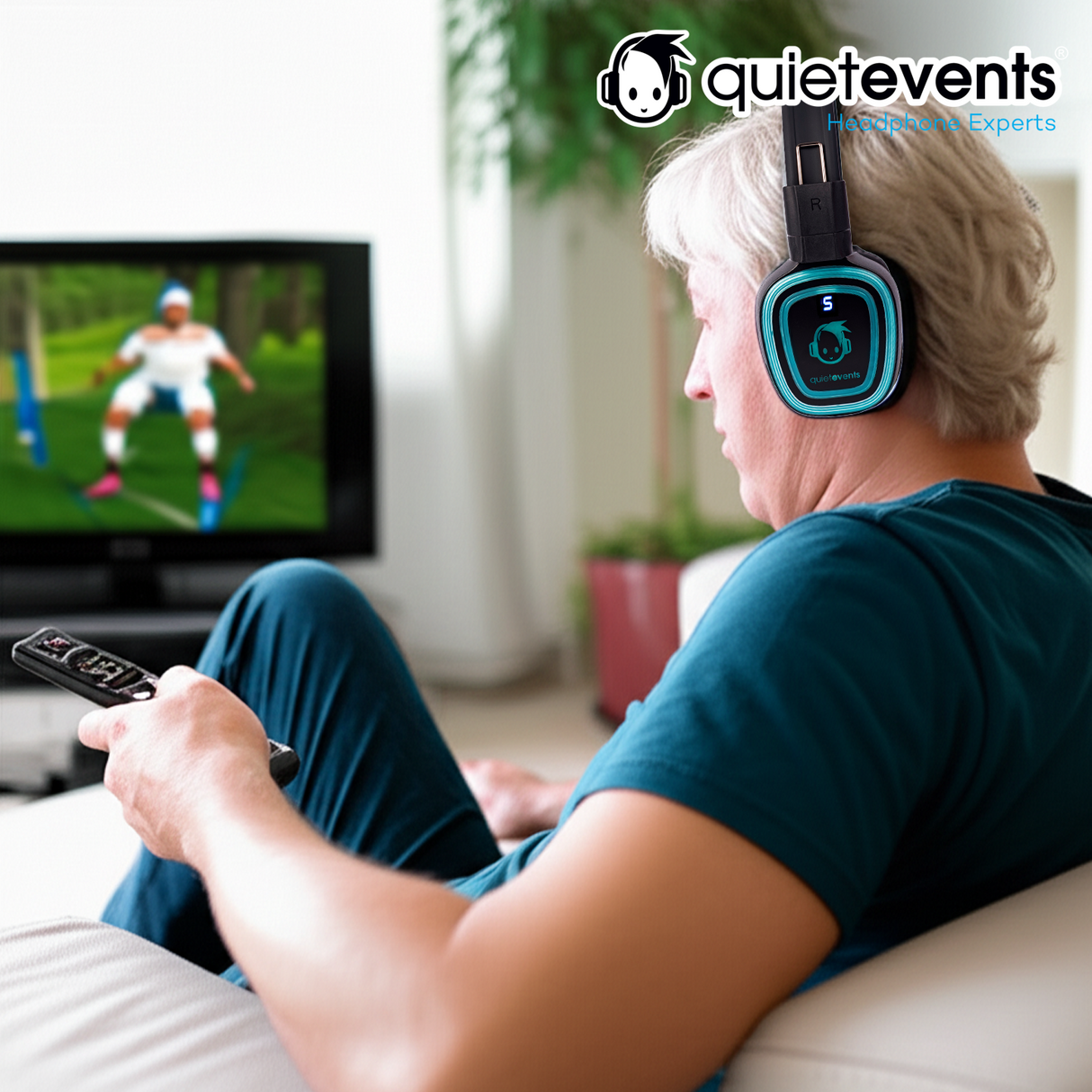 Man wearing QuietEvents headphones watching TV in a living room