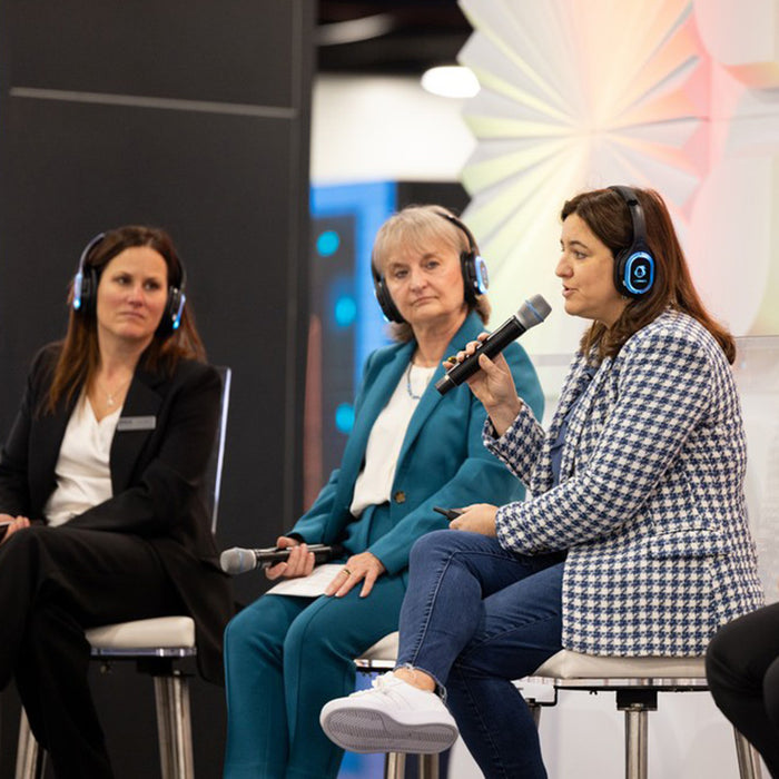 Quiet Events Silent Disco headphones for conferences a group of three women with headphones as speakers.