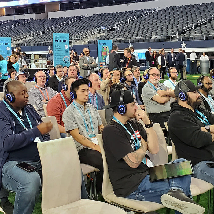 Quiet Events Silent Disco headphones for convention breakouts a group of people with headphones sitting listening