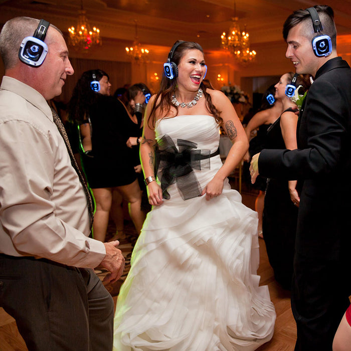 Quiet Events Silent Disco headphones for dance parties a newly wed couple at their reception night dancing and having fun wearing headphones