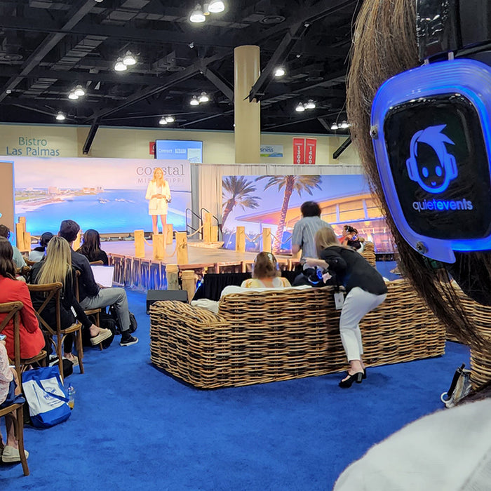 Quiet Events Silent Disco headphones for expos a group of people with headphones starring at catwalk