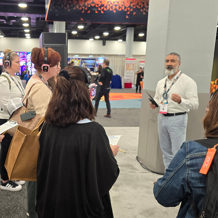 Quiet Events Silent Disco headphones for expos a group of people with headphones standing and listening to a speaker