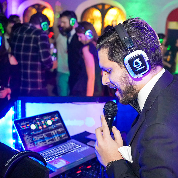 Silent Disco headphones for volume control. An MC speaking while DJing and using headphones