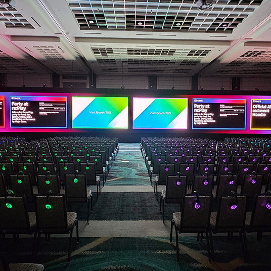 Silent Disco headphones for silent conferences with headphones on a seat with screens.