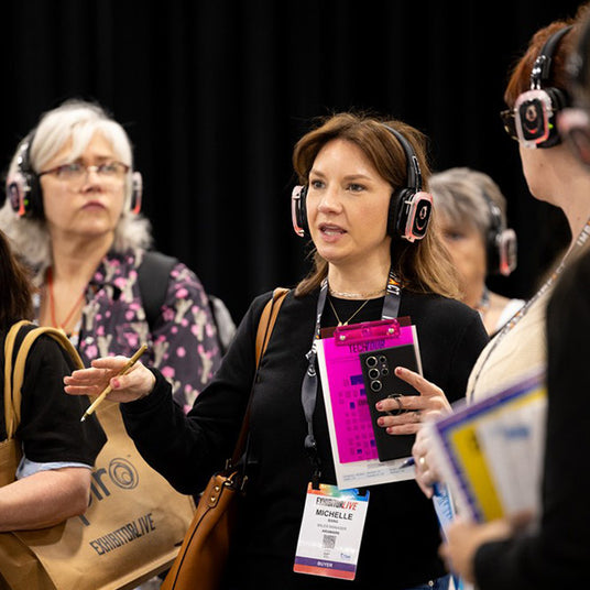 Silent Disco headphones for other quiet events.  Women wearing headphones and paying attention to a particular speaker.