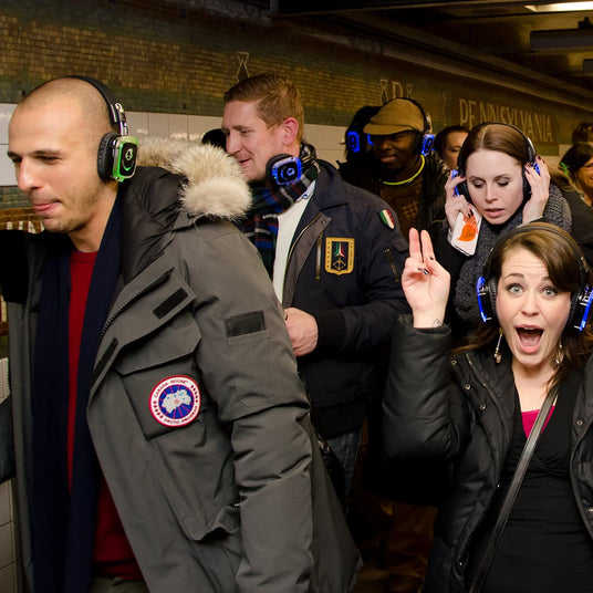 Attendees switching channels on LED silent disco headphones