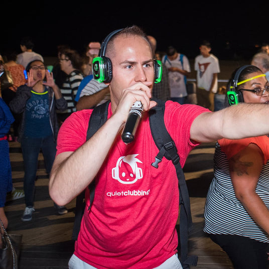 Crowd at an outdoor silent disco wearing wireless headphones