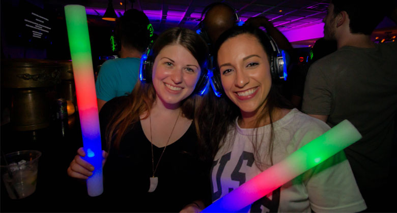 Two lady holding led light with headphones