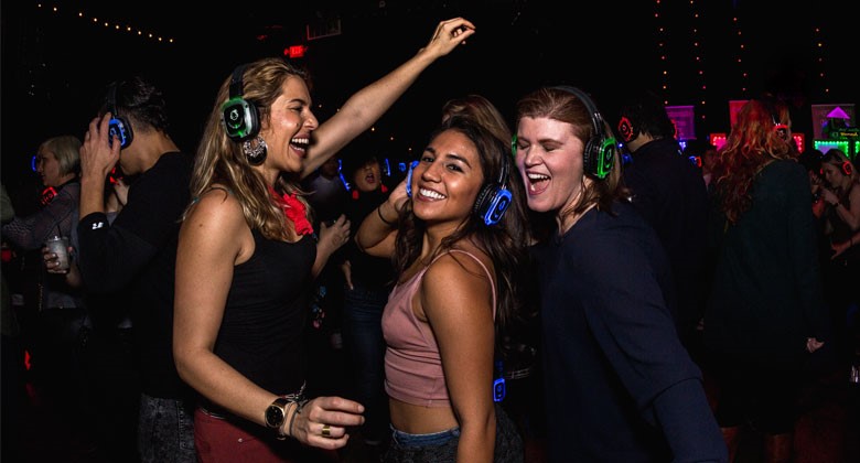 Three ladies dancing with headphones