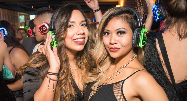 Best friends enjoying the party with headphones