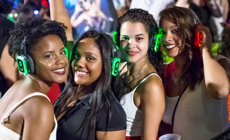 Four girls enjoying the party with headphones